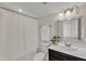 Bright bathroom featuring a shower with curtain, white fixtures, and decorative accents at 1272 Brown Velvet Ln, Apex, NC 27523
