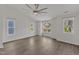 Spacious bedroom featuring hardwood floors, a ceiling fan, and bright natural light at 1272 Brown Velvet Ln, Apex, NC 27523