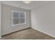Cozy bedroom with wood-look floors and a large, bright window at 1272 Brown Velvet Ln, Apex, NC 27523