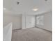 Upstairs bonus room with carpeted floors, natural light, and double doors at 1272 Brown Velvet Ln, Apex, NC 27523