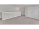 Upstairs bonus room with carpeted floors, paneled doors, and white trim at 1272 Brown Velvet Ln, Apex, NC 27523