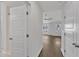 Bright hallway showcasing hardwood floors, white walls, and natural light from the window at 1272 Brown Velvet Ln, Apex, NC 27523