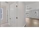Bright hallway showcasing tile flooring, white walls, and natural light from the window at 1272 Brown Velvet Ln, Apex, NC 27523
