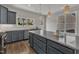 A modern kitchen boasting gray cabinets, stainless steel appliances, and a granite countertop island at 1272 Brown Velvet Ln, Apex, NC 27523