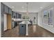 A spacious kitchen featuring gray cabinets, stainless steel appliances, and a large island with granite countertops at 1272 Brown Velvet Ln, Apex, NC 27523