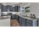 A well-appointed kitchen with gray cabinets, granite countertops, stainless steel appliances, and a modern aesthetic at 1272 Brown Velvet Ln, Apex, NC 27523