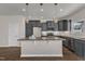 Spacious kitchen with granite countertops, stainless appliances, gray cabinets, and a large kitchen island at 1272 Brown Velvet Ln, Apex, NC 27523