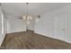 Open-concept living area featuring hardwood floors and stylish lighting at 1272 Brown Velvet Ln, Apex, NC 27523