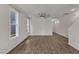 Bright living space with large windows, hardwood floors, and modern ceiling fan at 1272 Brown Velvet Ln, Apex, NC 27523