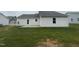 Backyard of a home featuring a back door, vinyl siding, and a grassy area at 139 Oakfield Trace Dr, Four Oaks, NC 27524