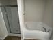 Bathroom featuring a shower and a bathtub with wood look floors at 139 Oakfield Trace Dr, Four Oaks, NC 27524