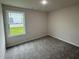 Cozy bedroom featuring plush carpet and natural light at 139 Oakfield Trace Dr, Four Oaks, NC 27524