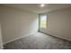 Cozy bedroom featuring plush carpet and natural light at 139 Oakfield Trace Dr, Four Oaks, NC 27524