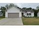 Charming single-story home featuring a gray garage door, light gray siding, and a well-manicured lawn at 139 Oakfield Trace Dr, Four Oaks, NC 27524