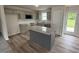 Modern kitchen with stainless steel appliances, kitchen island with granite countertops, and door to exterior at 139 Oakfield Trace Dr, Four Oaks, NC 27524