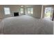 Bright, open living room with a fireplace, plush carpet, and lots of natural light from several windows at 139 Oakfield Trace Dr, Four Oaks, NC 27524