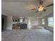 Bright, open floor plan featuring the living room, kitchen island, and hardwood flooring at 139 Oakfield Trace Dr, Four Oaks, NC 27524