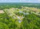 Stunning aerial view of community with pond, surrounded by lush, mature trees and landscaping at 140 Crystal Pl, Benson, NC 27504