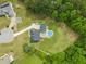 Aerial view of a home with pool, deck, and expansive lawn nestled among mature trees at 140 Crystal Pl, Benson, NC 27504