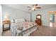 Bright bedroom featuring a patchwork quilt, ceiling fan, and pale blue walls at 140 Crystal Pl, Benson, NC 27504