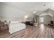 Spacious bedroom featuring wood floors, neutral walls, vaulted ceiling, and seating area at 140 Crystal Pl, Benson, NC 27504