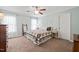 Bright bedroom featuring a patchwork quilt, ceiling fan, and pale blue walls at 140 Crystal Pl, Benson, NC 27504