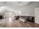 Spacious bedroom featuring wood floors, neutral walls, vaulted ceiling, and comfortable seating at 140 Crystal Pl, Benson, NC 27504