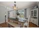 Charming dining area with hardwood floors, a rustic table, and stylish black and white curtains at 140 Crystal Pl, Benson, NC 27504