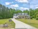 Charming home with a welcoming front porch, a three-car garage, and ample curb appeal at 140 Crystal Pl, Benson, NC 27504
