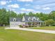 Beautiful two-story home with a large front porch and a spacious three-car garage at 140 Crystal Pl, Benson, NC 27504