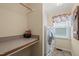 Convenient laundry room equipped with washer, dryer, and counter space at 140 Crystal Pl, Benson, NC 27504