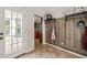 Functional mud room with wood paneling, hooks for storage, and a view into the kitchen at 140 Crystal Pl, Benson, NC 27504