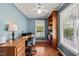 Well-lit home office featuring hardwood floors, a built-in bookcase, and a spacious desk at 140 Crystal Pl, Benson, NC 27504