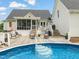 Poolside deck area with seating, ideal for enjoying the backyard and outdoor activities at 140 Crystal Pl, Benson, NC 27504