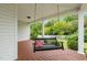 Relaxing porch swing on a spacious porch, perfect for enjoying the outdoor view at 140 Crystal Pl, Benson, NC 27504