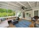 Comfortable sun room with seating, ceiling fan, and a view of the backyard at 140 Crystal Pl, Benson, NC 27504