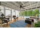 Relaxing sun room with comfortable seating, ceiling fan, and a view of the pool and backyard at 140 Crystal Pl, Benson, NC 27504