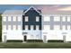 Beautiful townhome featuring varying colors, green lawn, and covered doorways for an inviting place to live at 1486 Hasse Ave, Apex, NC 27502