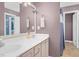 Bathroom featuring a nice vanity with a double sink, framed mirror, modern fixtures, and tile flooring at 1576 Cheves Rd, Zebulon, NC 27597
