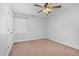 This bedroom has light-colored walls, neutral carpet, a ceiling fan, and a window at 1576 Cheves Rd, Zebulon, NC 27597