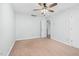 This bedroom features light walls, tan carpet, a ceiling fan, and an open doorway at 1576 Cheves Rd, Zebulon, NC 27597