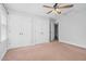 This bedroom features carpet, three white closets, and light-colored walls at 1576 Cheves Rd, Zebulon, NC 27597