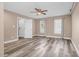 Bedroom with neutral paint, wood floors, ceiling fan, and two bright windows at 1576 Cheves Rd, Zebulon, NC 27597