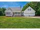 Charming home with a well-maintained lawn, attached garage, and front porch with an American flag at 1576 Cheves Rd, Zebulon, NC 27597