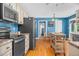 Spacious kitchen featuring stainless steel appliances, wooden floors and plenty of storage space at 1576 Cheves Rd, Zebulon, NC 27597