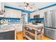 Well-lit kitchen featuring stainless steel appliances, butcher block island, and hardwood floors at 1576 Cheves Rd, Zebulon, NC 27597