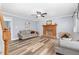 Bright living room featuring wood-look floors, a brick fireplace, and neutral paint, creating a cozy atmosphere at 1576 Cheves Rd, Zebulon, NC 27597