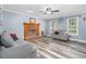 Comfortable living room showcasing a brick fireplace, wood-look floors, and stylish decor for a welcoming space at 1576 Cheves Rd, Zebulon, NC 27597