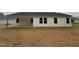 Backyard view showing house with white siding, many windows, and a concrete porch at 163 Oakfield Trace Dr, Four Oaks, NC 27524