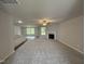 Bright living room with a fireplace, ceiling fan, and lots of natural light at 163 Oakfield Trace Dr, Four Oaks, NC 27524